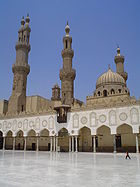 Three minarets and a onion-shaped dome tower above al-Azhar's marble courtyard adorned by pillared Islamic craftsmanship